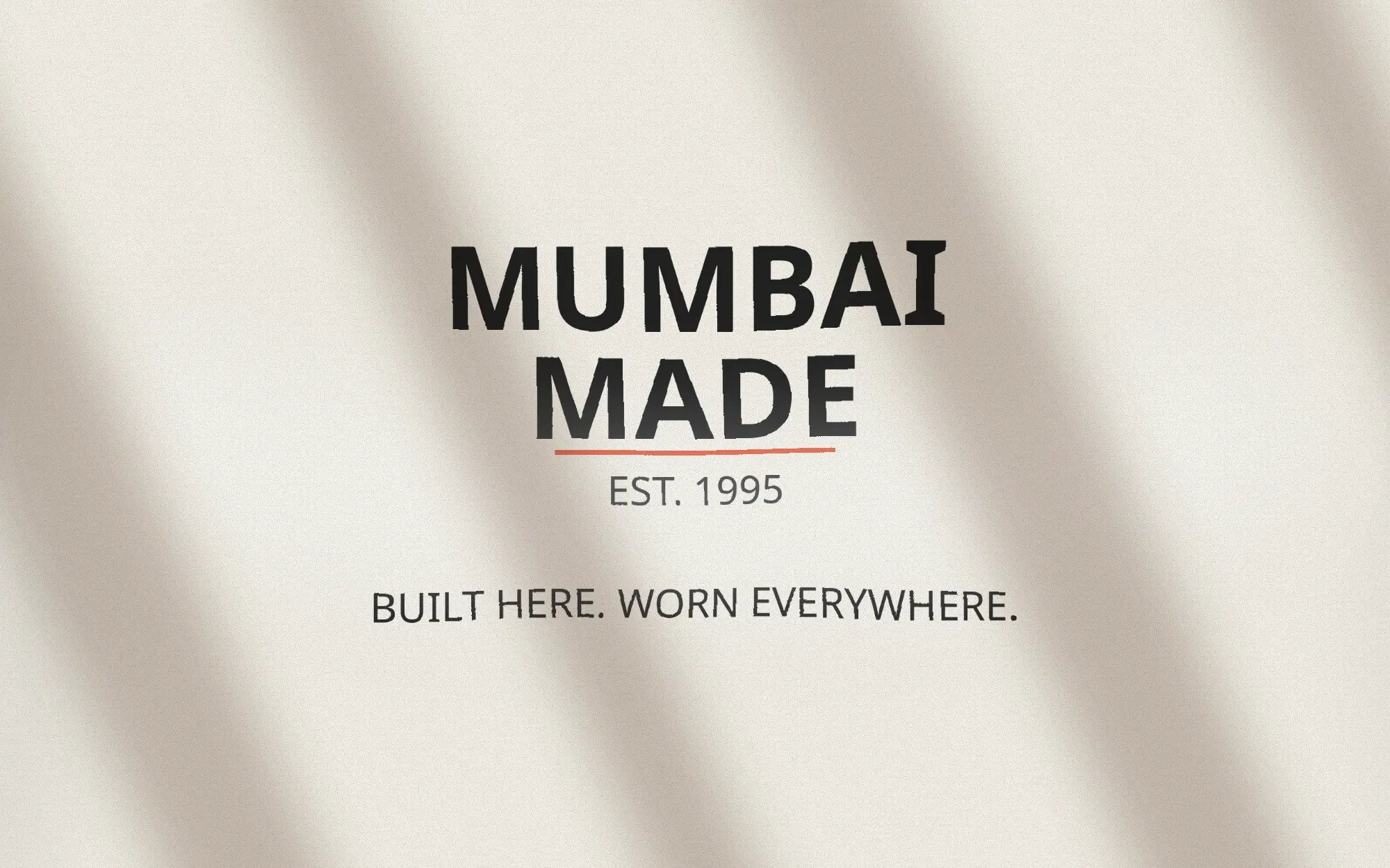 Close-up of the Mumbai Made print: MUMBAI MADE, Est. 1995, Built here. Worn everywhere.